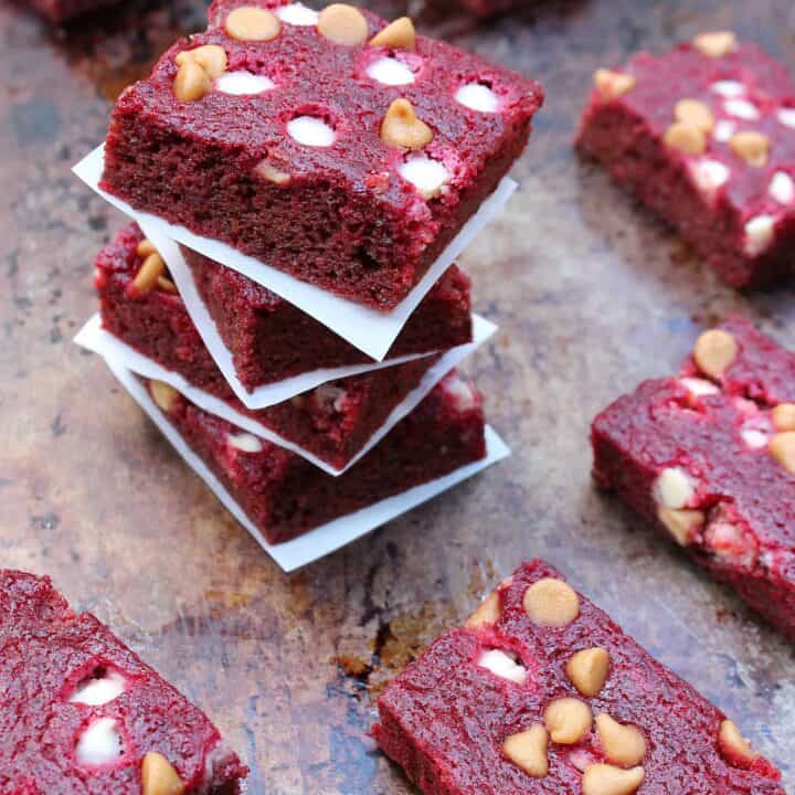 a tray full of beet bars - some stacked and some lying around the stacked ones.