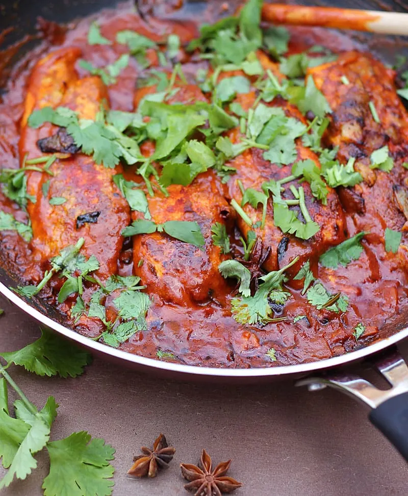 The rich color of this curry is from the paprika, cumin, coriander, cayenne and turmeric I dredged the fish with before  cooking them in a tomato, ginger, garlic, onion and coconut milk sauce. @RunninSrilankan
