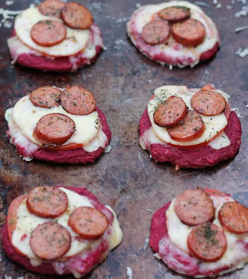 beet pizettes with andouille and pepper jack and tomato