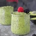 Two glass containers with creamy avocado chia pudding in them - one topped with berries.