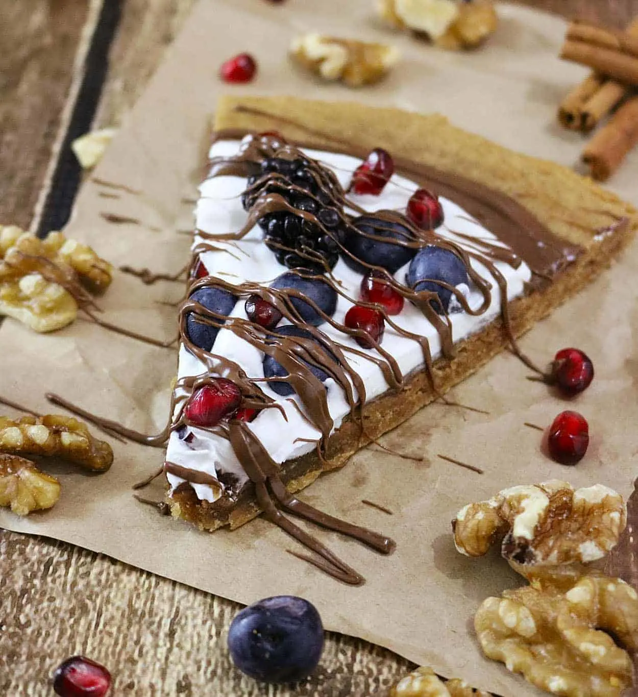 Walnut Coconut Cookie Cake with chocolate, berries, pomegranate arils, and coconut whipped cream - also gluten free