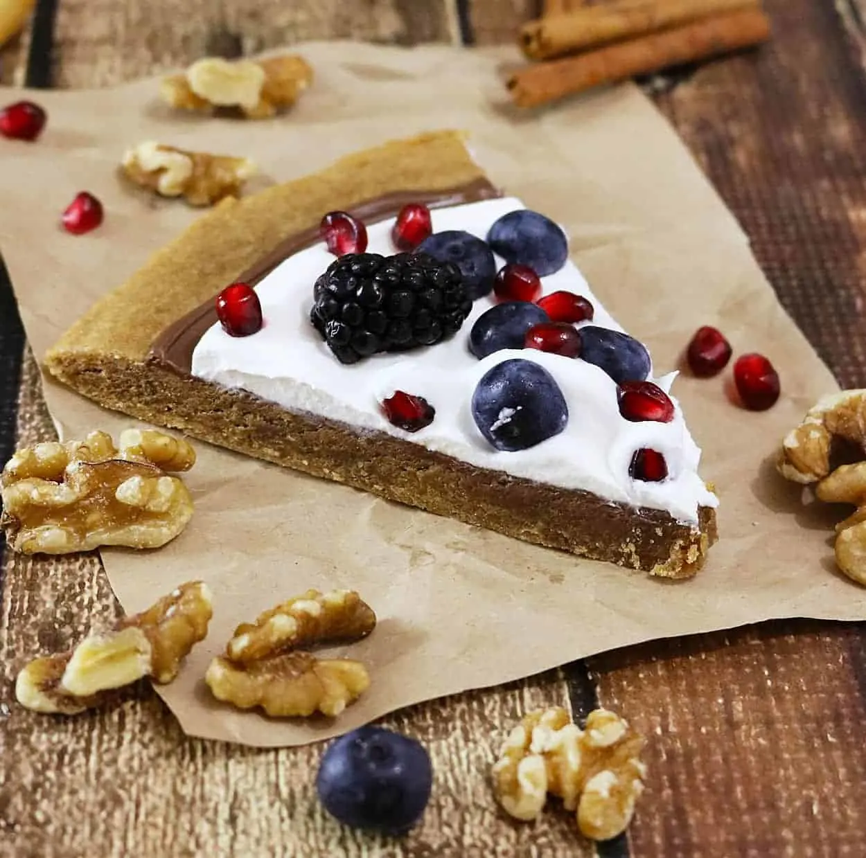 Walnut Coconut Cookie Cake with chocolate, berries, pomegranate arils, and coconut whipped cream - also gluten free