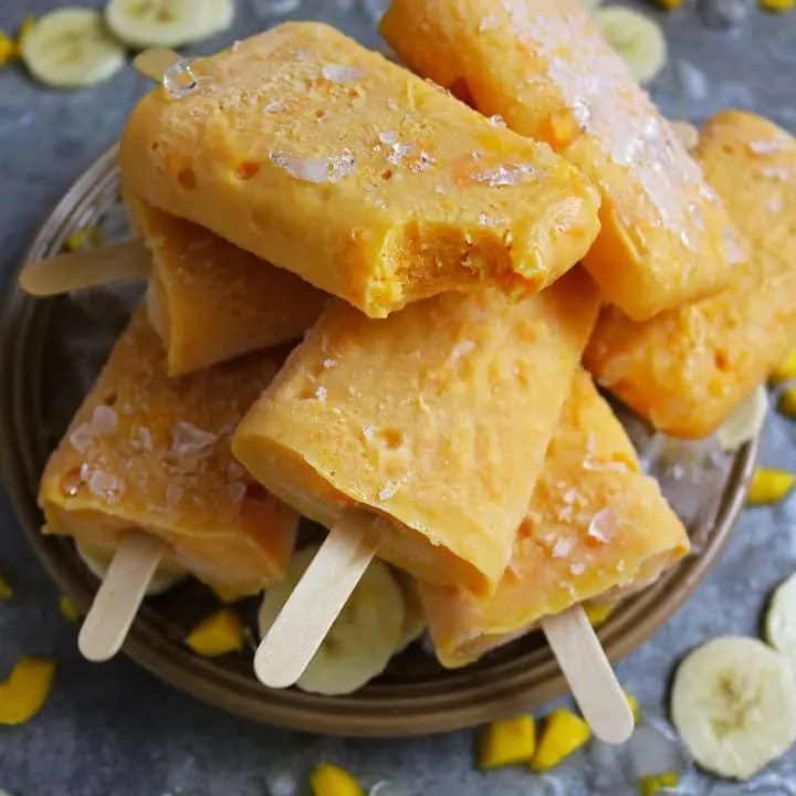 Bite of Mango And Banana Protein Popsicles on Plate