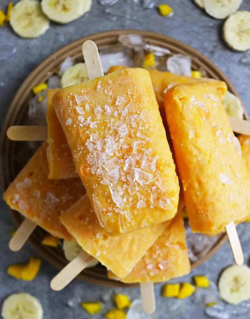 Mango And Banana Protein Popsicles On A Plate