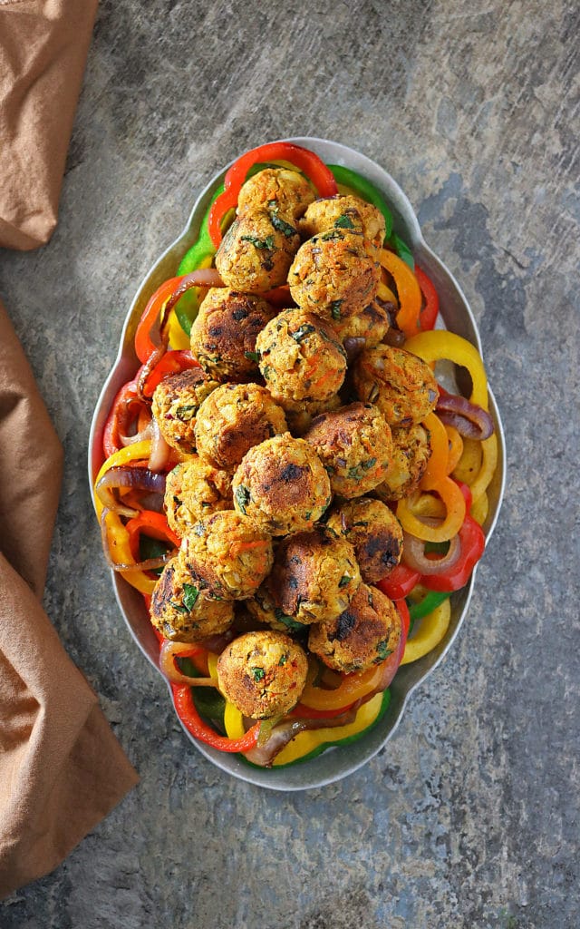 Packed full of veggies and a boatload of aromatic spices, this Easy Vegetarian Meatballs Recipe results in my favorite meatless veggie balls.  So tasty and festive!
