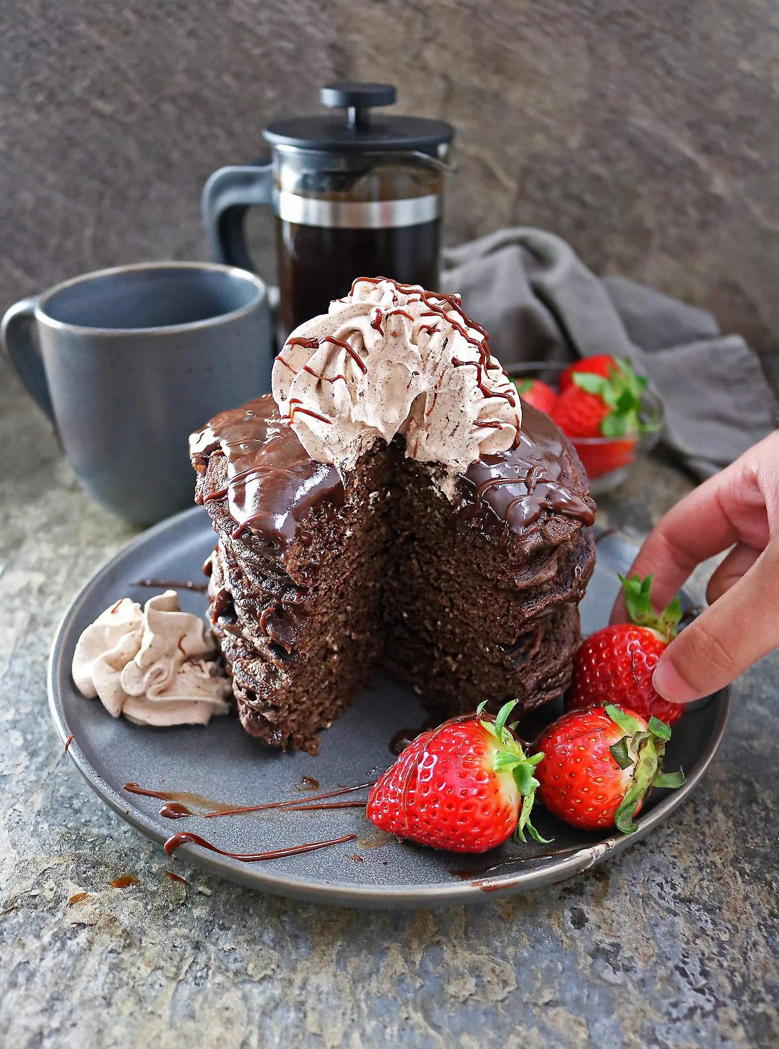 Easy Chocolate Coffee Pancakes with Chocolate Sauce and chocolate whipped cream and strawberries