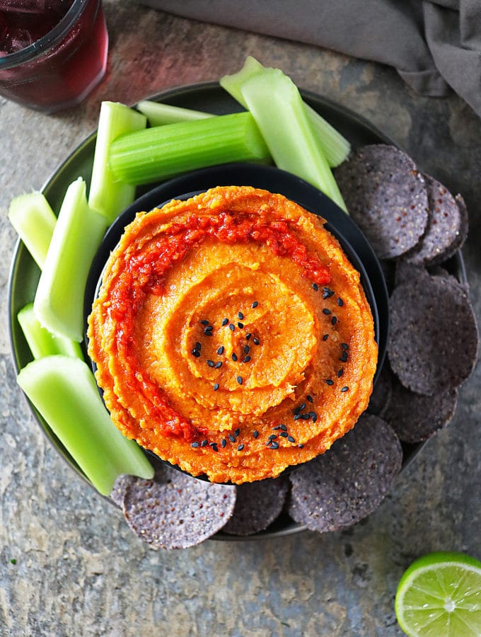 Overhead view of Butternut Squash Dip with Celery and Chips on plate.