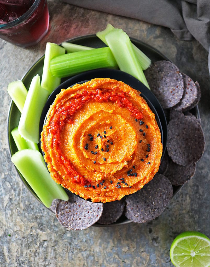 Overhead view of Butternut Squash Dip with Celery and Chips on plate.