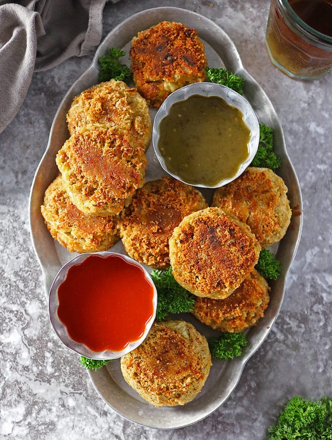 Overhead photo of Curry Spiced Lentil Burgers with 2 dipping sauces.
