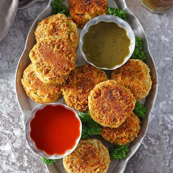Overhead photo of Curry Spiced Lentil Burgers with 2 dipping sauces.