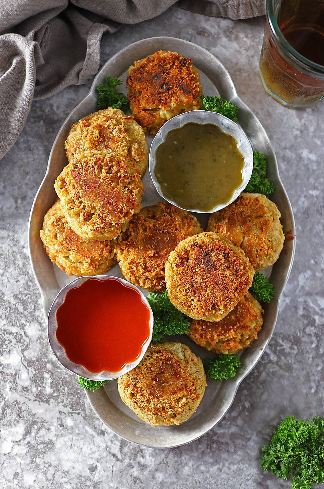 Overhead photo of Curry Spiced Lentil Burgers with 2 dipping sauces.