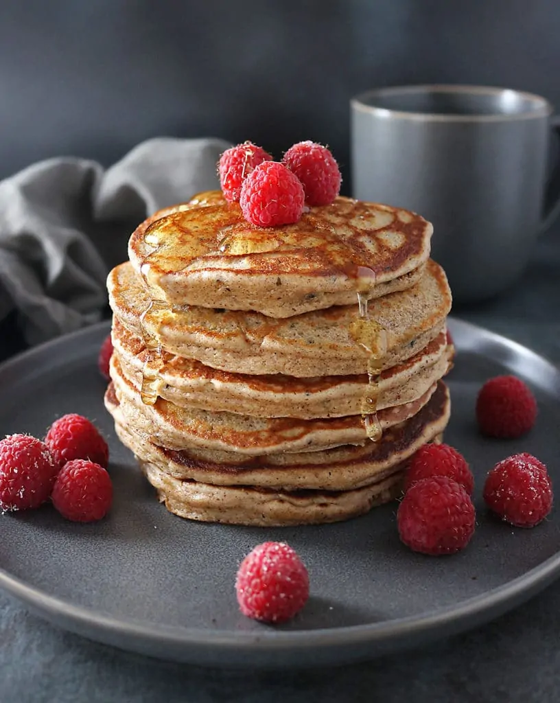 Stack of four Almond Hemp Pancakes with raspberries