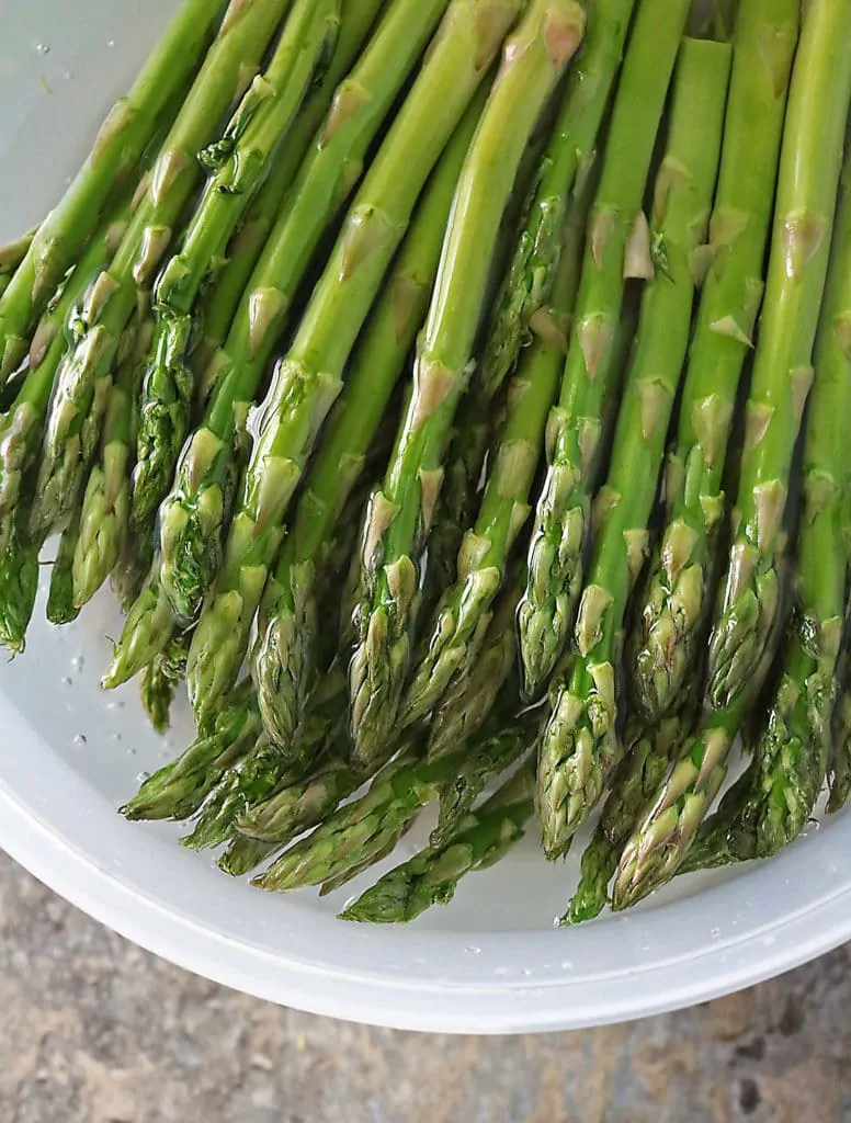 Asparagus submerged in cold water to remove grit