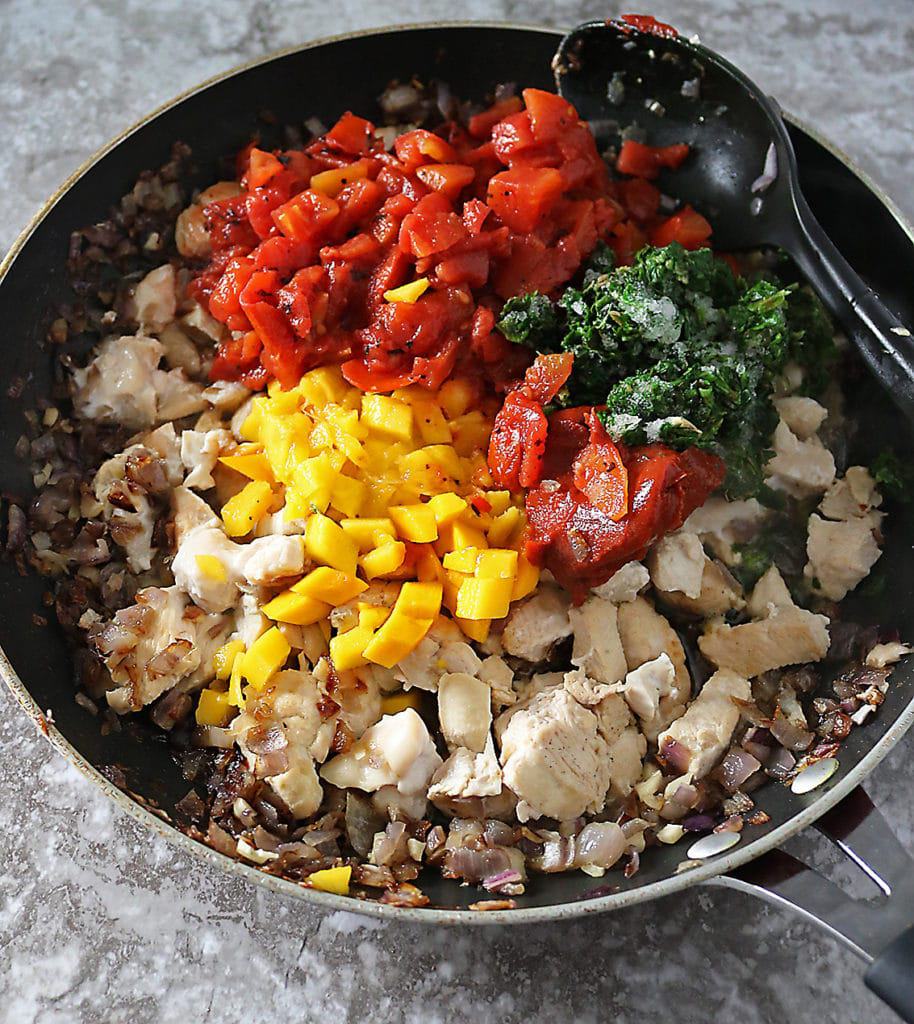 Pan with ingredients for making mango chicken