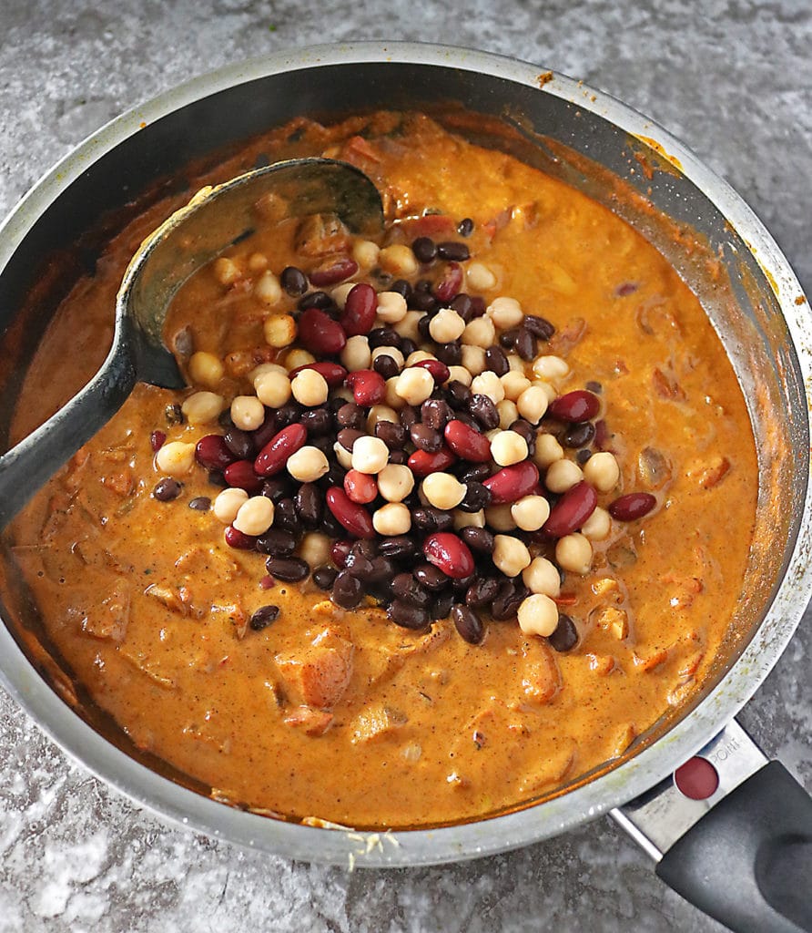 Pan with thick curry sauce and three beans added into it