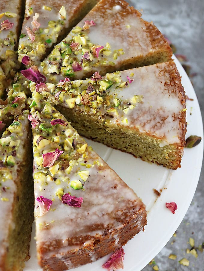 Overhead photo of Ottolenghi's Pistachio Rose Semolina Cake cut into slices
