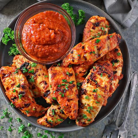 Overhead photo of Roasted Red Pepper Dip And Chicken cooked after being marinated in roasted red pepper dip.