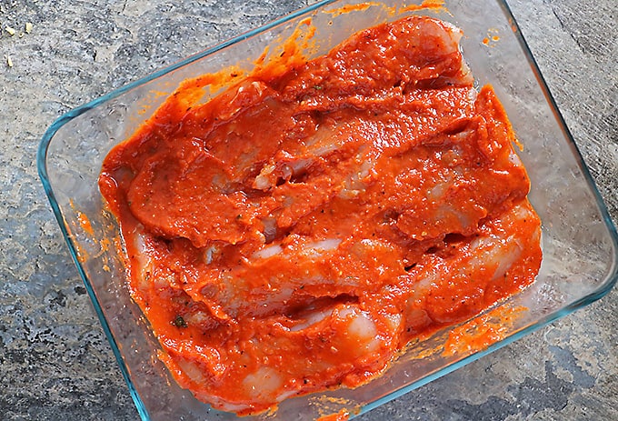 Chicken marinading in homemade roasted red pepper dip and marinade