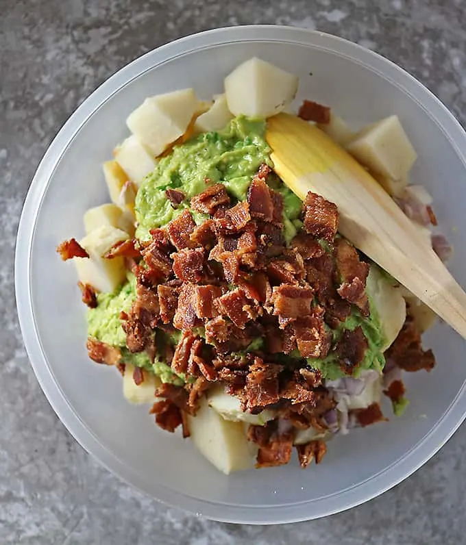 Photo of mixing together potatoes, bacon, and avocado dressing