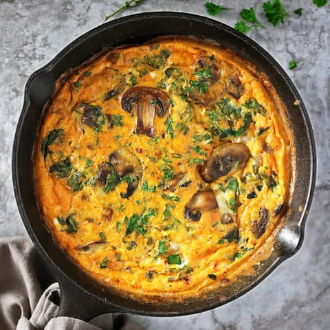 Overhead view of skillet with mushroom spinach bake