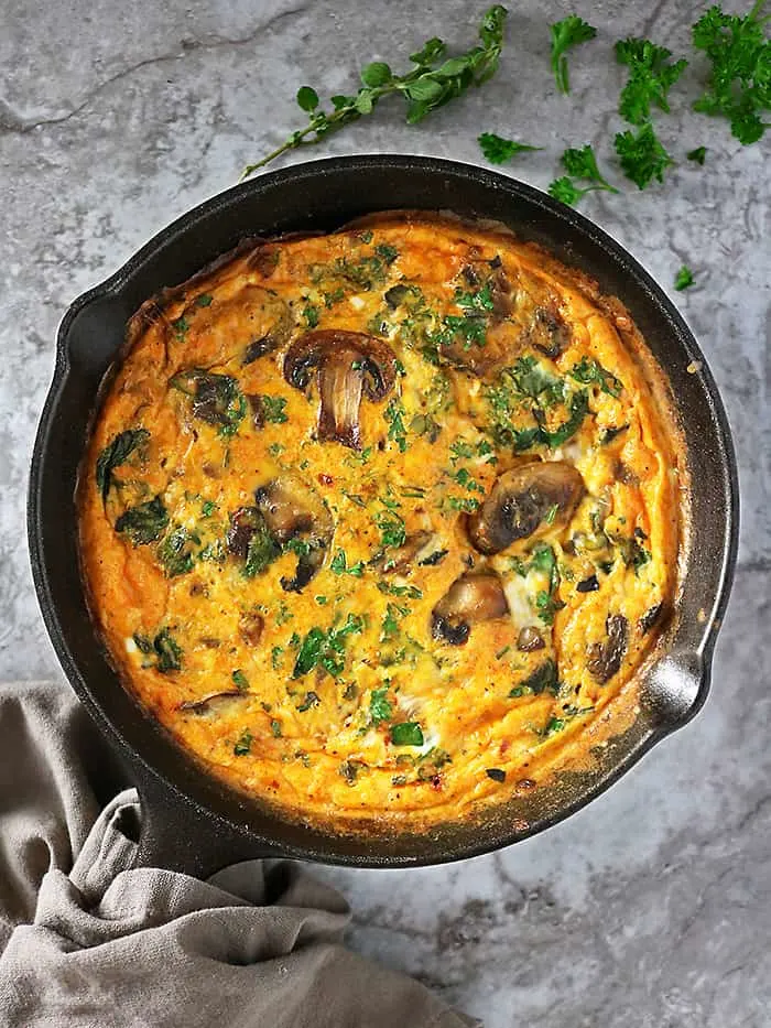 Overhead view of skillet with mushroom spinach bake