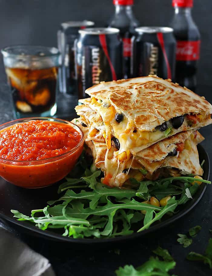 Photo of cheesy veggie quesadillas with roasted red pepper salsa and Coca-Cola in background