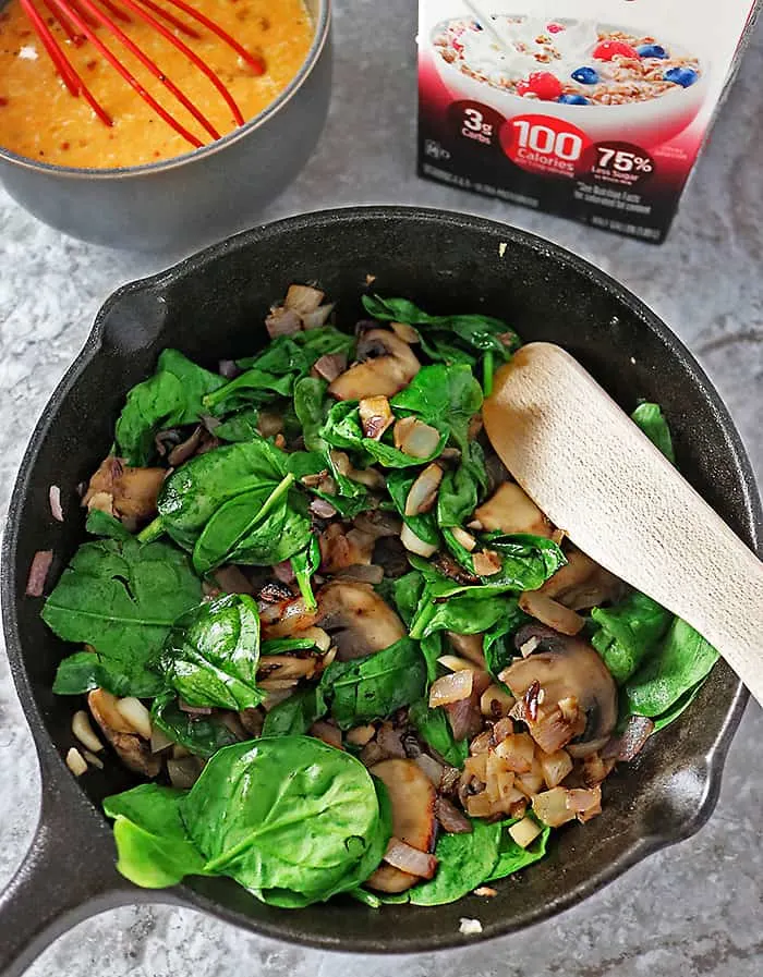 Sauteing mushrooms, spinach, onions and garlic