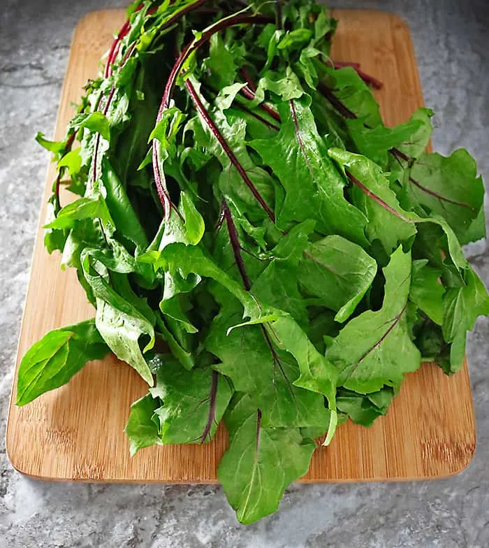 Dandelion Greens on a cutting board #dandelion