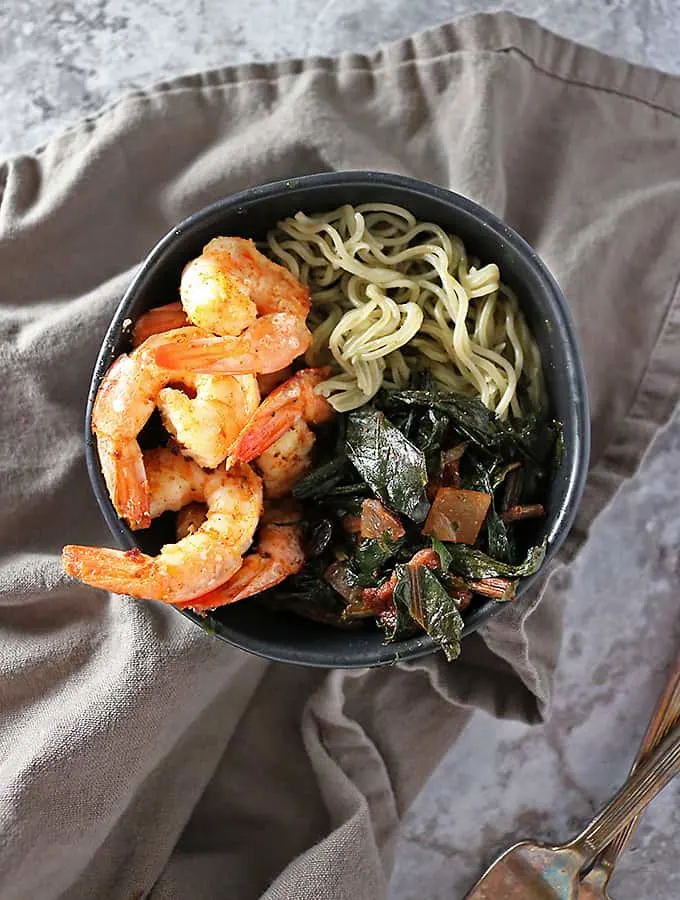 Dandelion root sauté with bacon, spiced shrimp and rice ramen in a bowl #dandelion