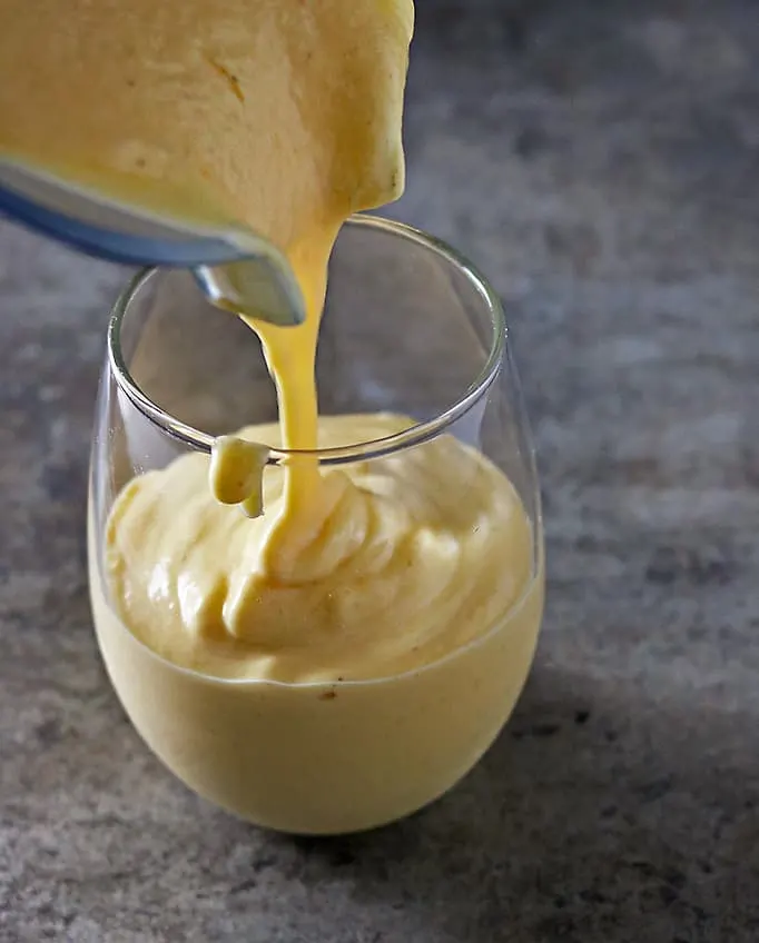 Pouring Jackfruit Mango Smoothie into Glass