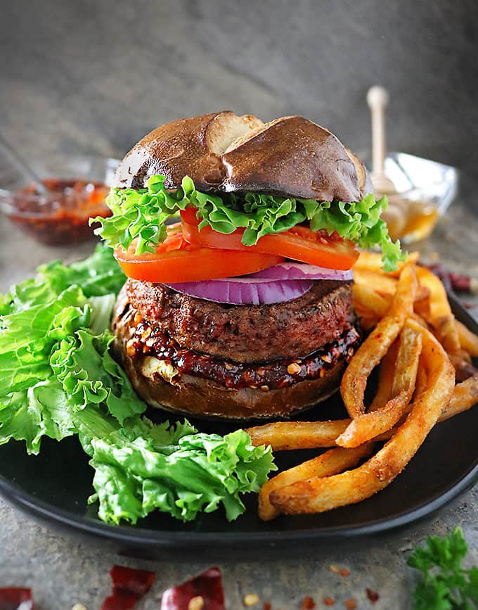 Photo of mile high plant based Beyond Burgers with Sweet Chili Sauce