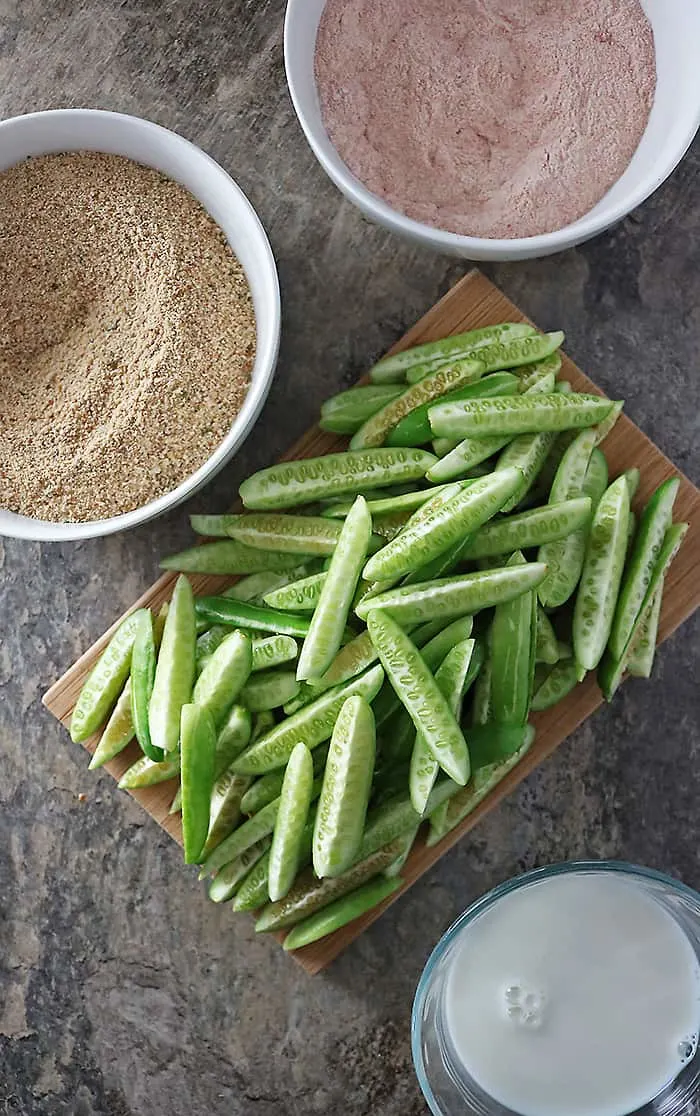 Sliced Tindora Breadcrumbs, milk and flour mix in preparation to make tindora fries