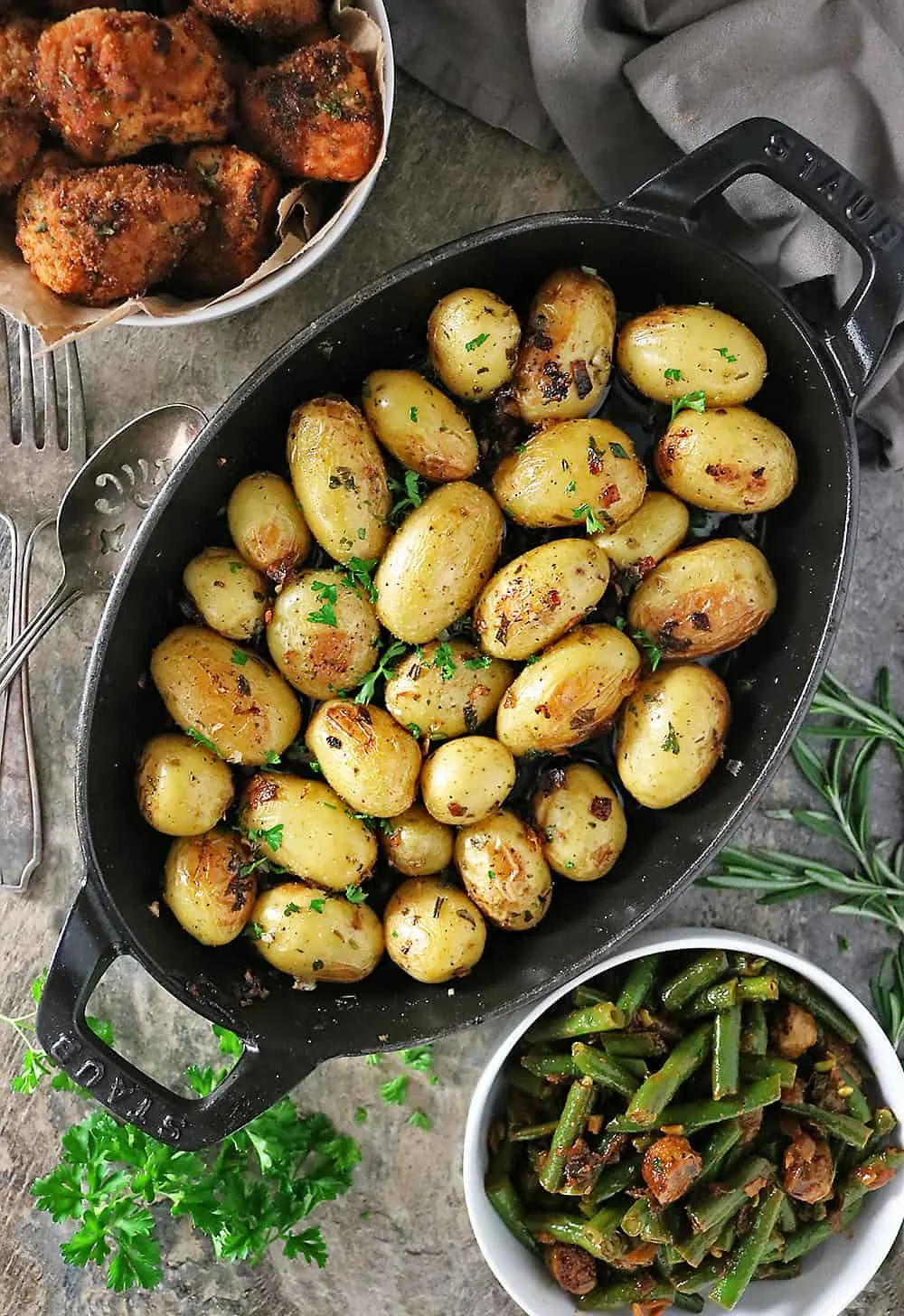 Cast-iron herb garlic potatoes, beans and sausage and fried baked chicken photo