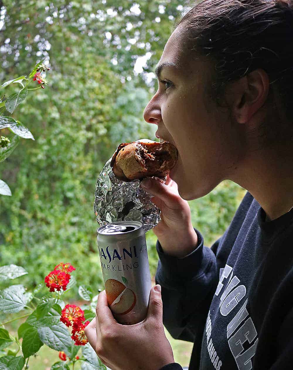 Photo of my daughter enjoying Stuffed Chicken Buns after fall hiking