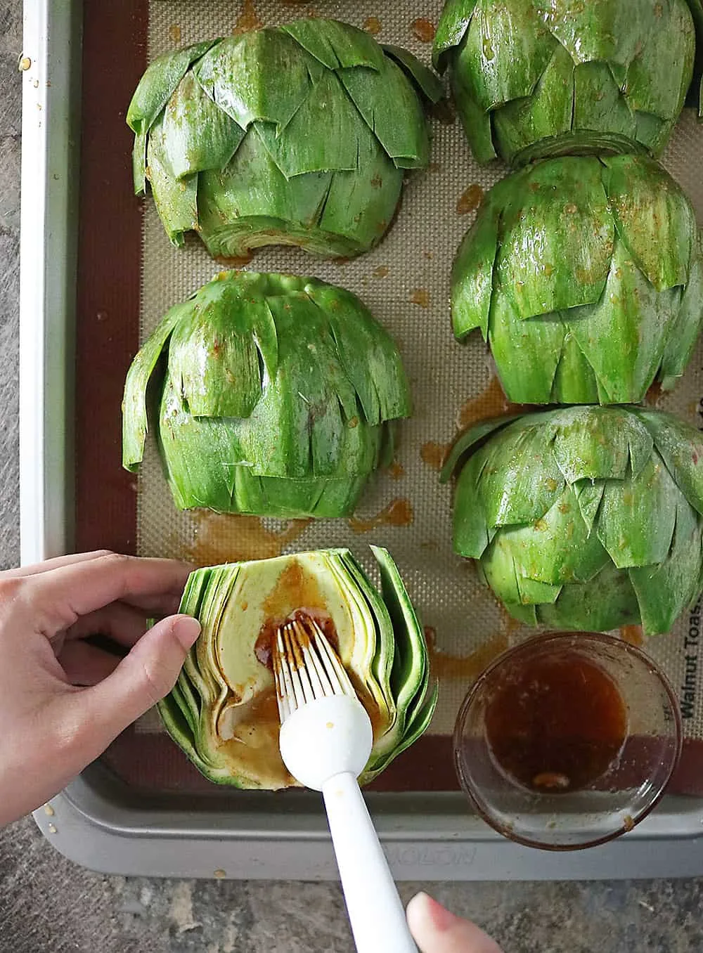 Sweet Spicy Orange Chili Sauce slathered on artichokes