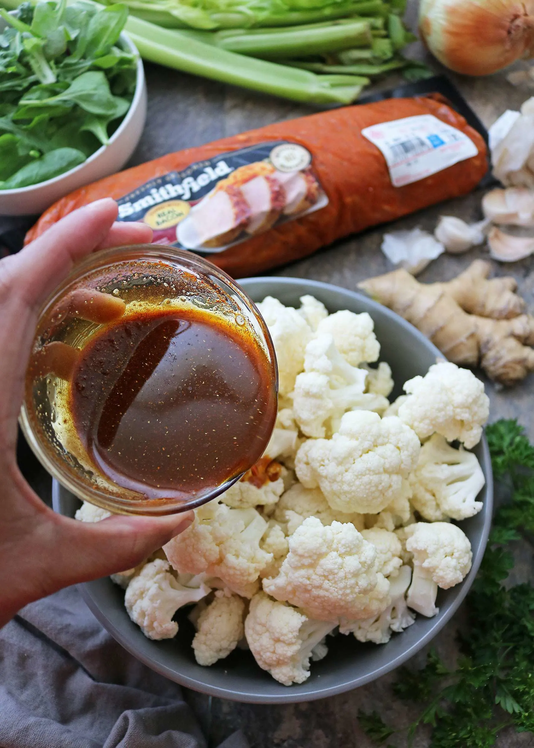 Coating Cauliflower With Turmeric and Spices for dinner bowl.