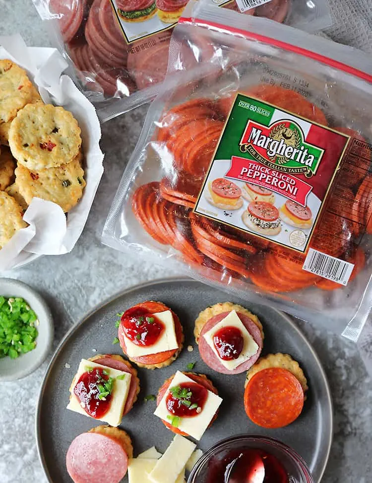Putting together Pepperoni Cheddar Jalapeno Cracker Appetizers for holiday parties