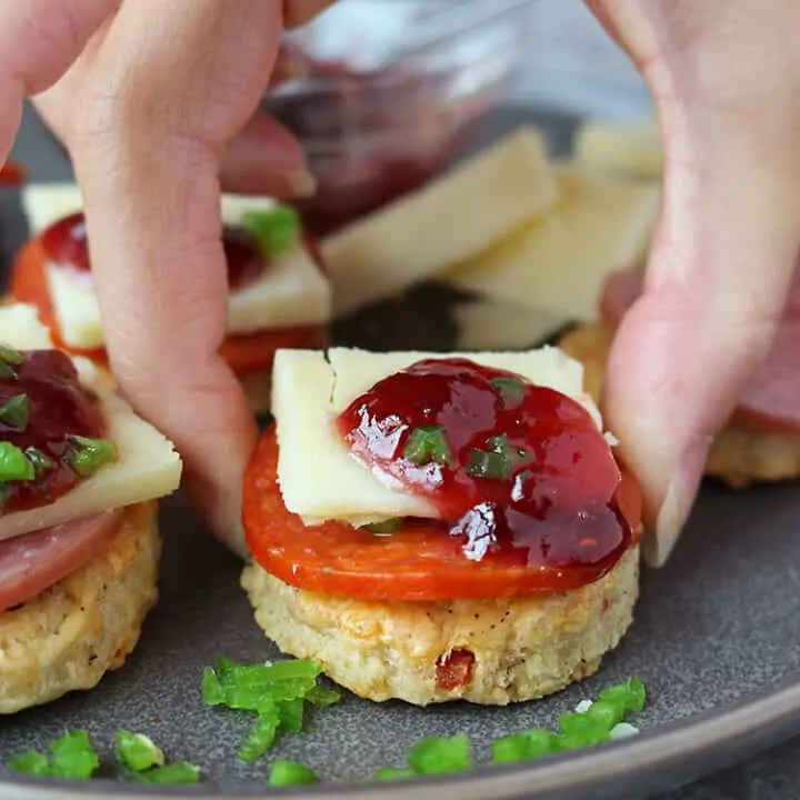 These homemade Cheddar Jalapeño Pepperoni Cracker appetizers are a favorite in our home. The unique flavor combination of these crackers with Margherita® Thick Sliced Pepperoni (or Margherita® Hard Salami), a piece of cheddar, sweet raspberry jam and crisp and fresh jalapeño, has our tastebuds singing!