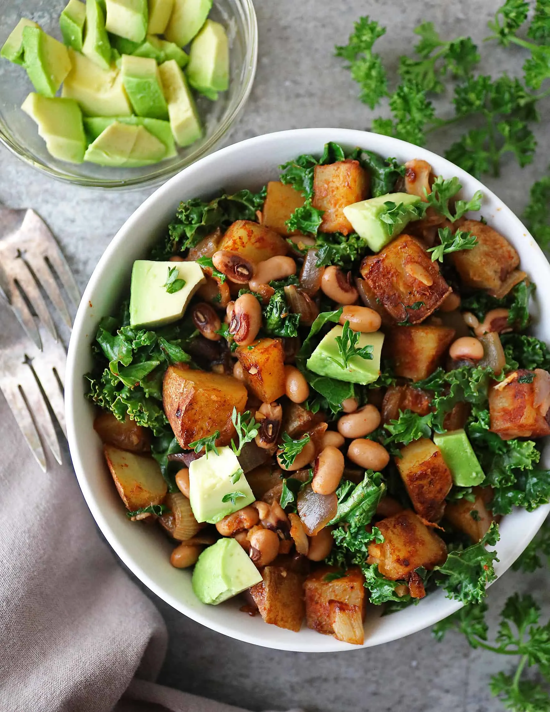 Vegan Black-Eyed Peas Recipe with Greens Hash in a bowl with a fork on the side.