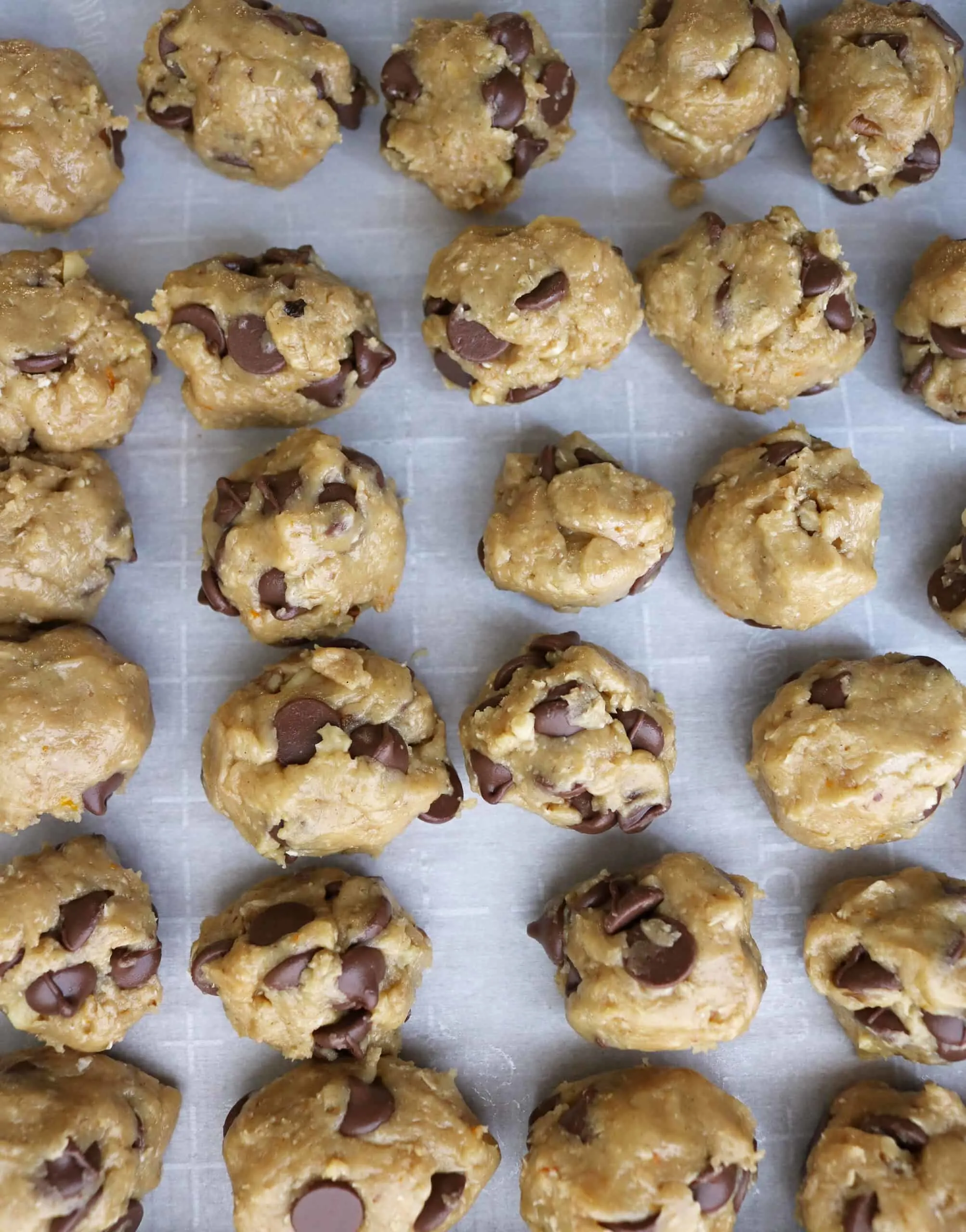 Tray of balls of Orange Chocolate Chip Cookie dough ready to chill before baking.