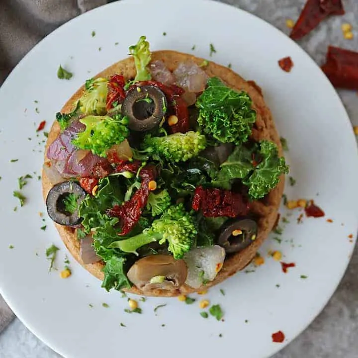 Super easy and quick, these Waffle Pizzas with a sautéed mix of kale, broccoli, onion, sundried tomatoes, mushrooms and olives for dinner.