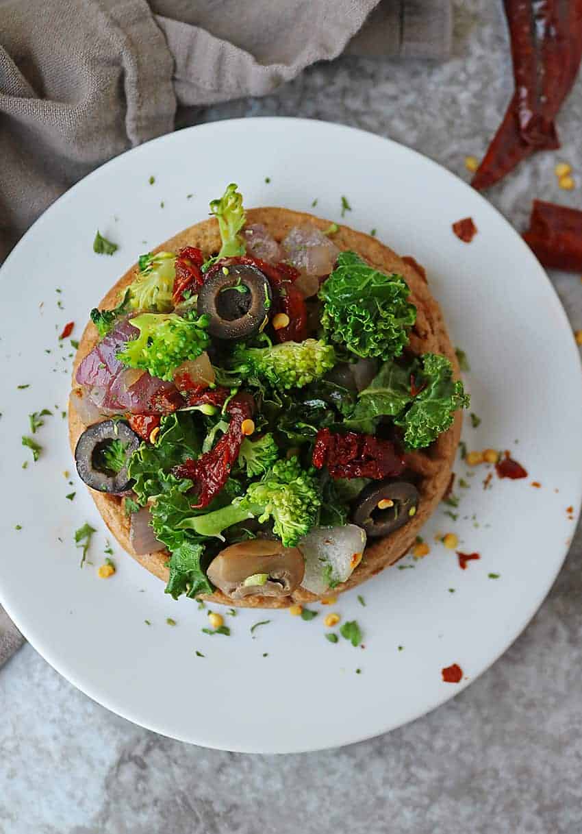 Super easy and quick, these Waffle Pizzas with a sautéed mix of kale, broccoli, onion, sundried tomatoes, mushrooms and olives for dinner.