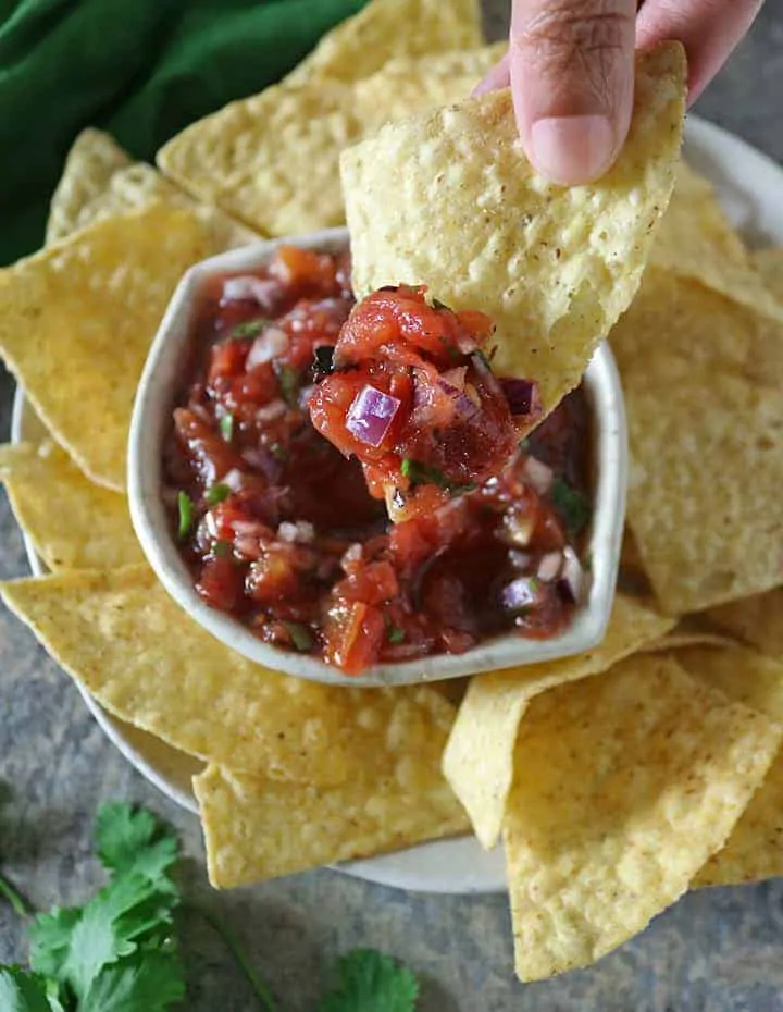 Tasty Chunky Easy Homemade Salsa on a corn tortilla chip.