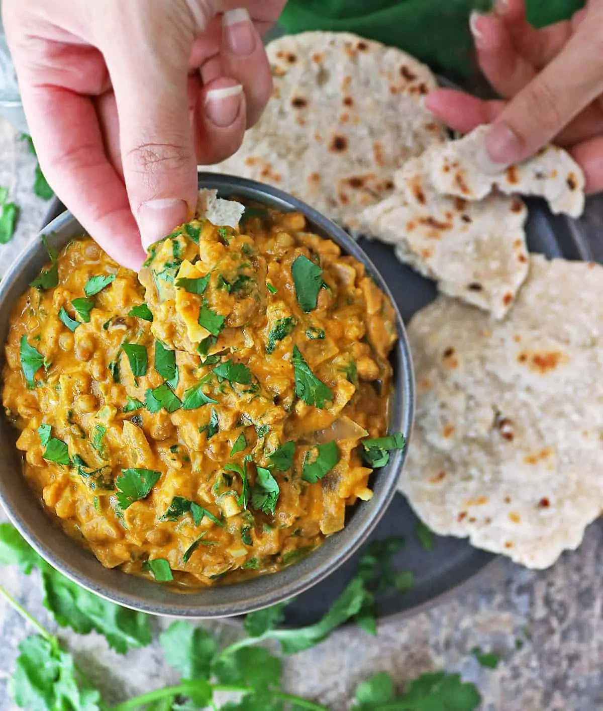 Enjoying a bowl of easy lentil curry with some sri lankan roti