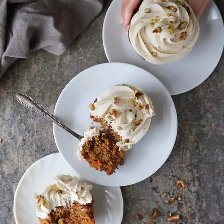 A flatlay of three plates with Carrot Cake Cupcakes.