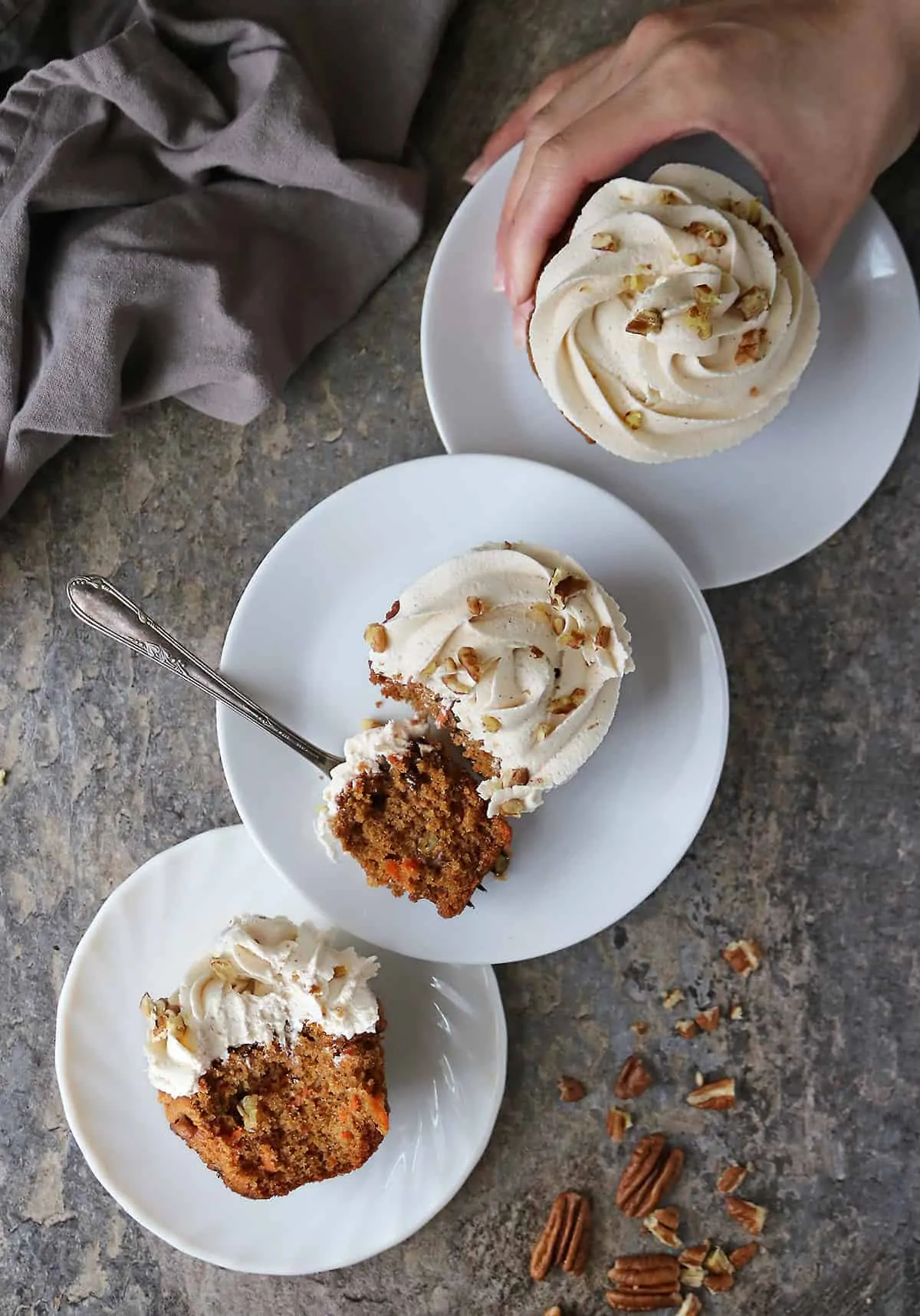 A flatlay of three plates with Carrot Cake Cupcakes.