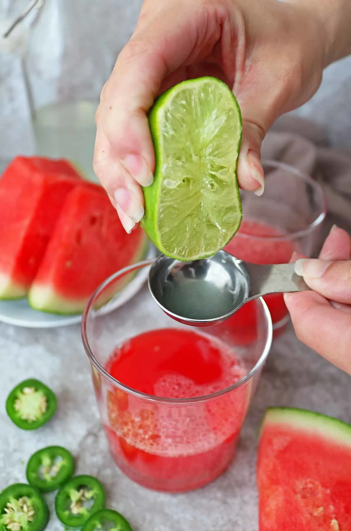 Adding in lime juice to make a watermelon paloma