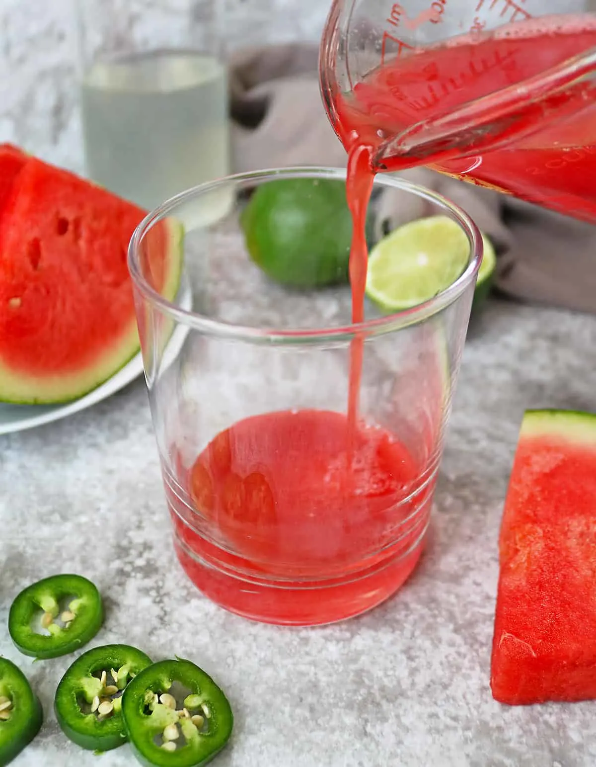 Pouring Delicious watermelon juice into a glass to make the paloma