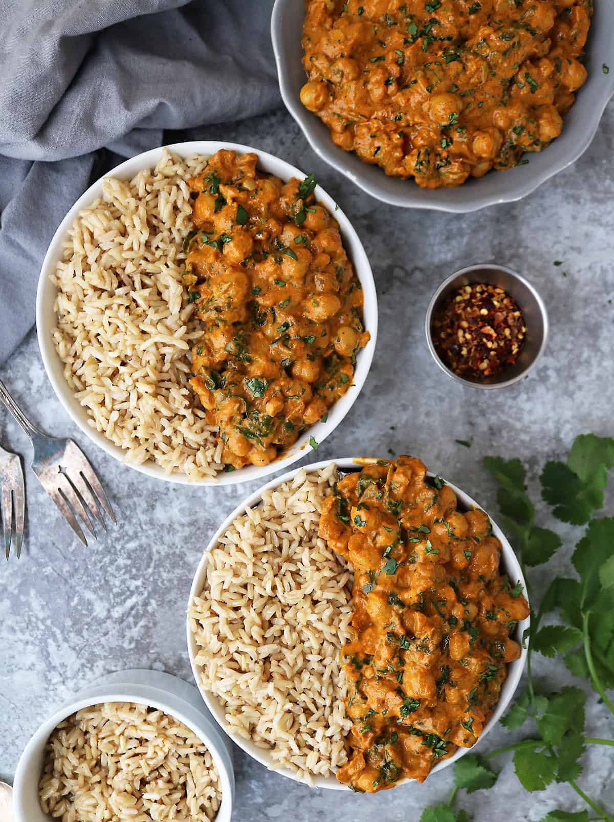 Two bowls with easy vegan chickpea spinach curry