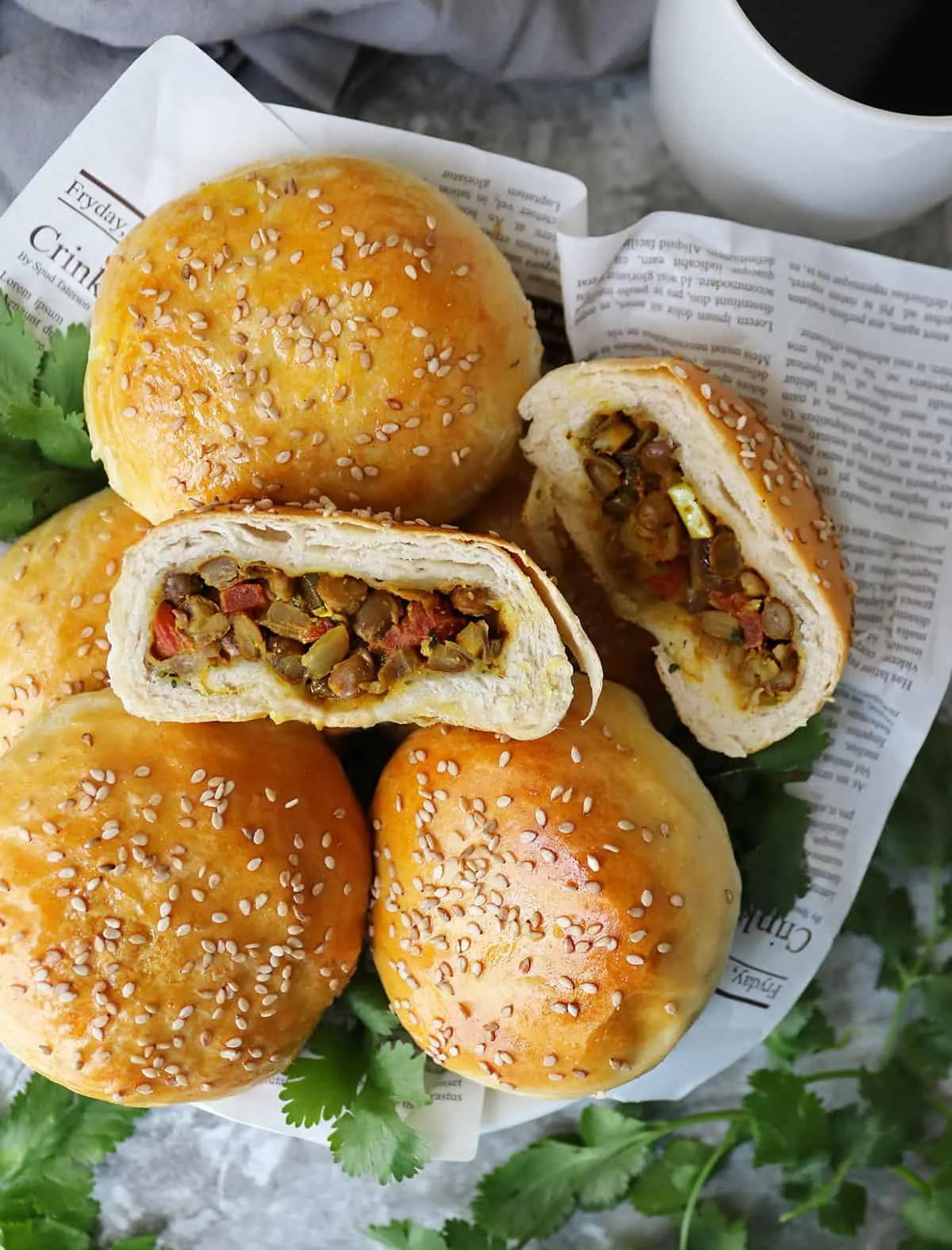 plate of stuffed buns with Ginger, garlic, onions, coriander, smoked paprika, turmeric, canned lentils, and canned tomatoes.